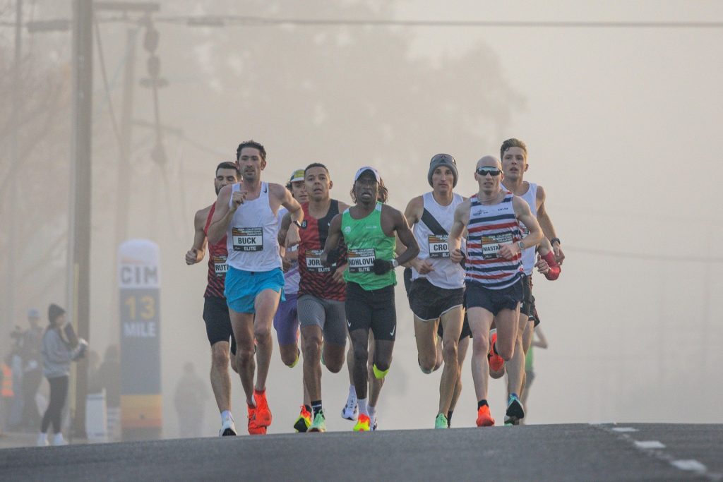 Marathon runner in motion blur representing sustained compliance program cadence over annual sprint